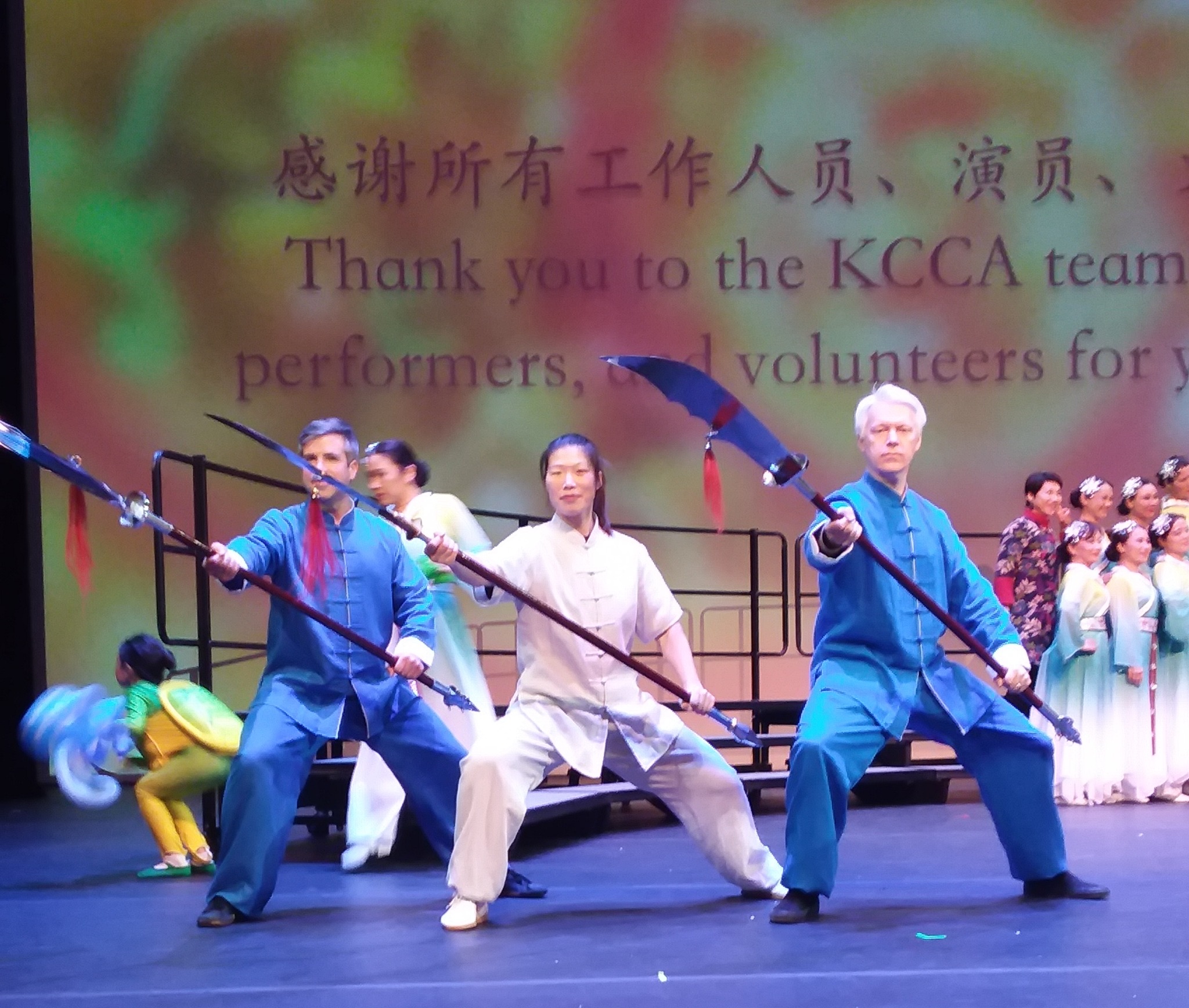 Brandon Stevens, Master Chen Huixian, and Aaron Crim performing traditional weapons on stage
