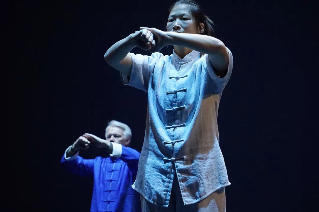 Master Chen Huixian and Aaron Crim performing the traditional salute on stage