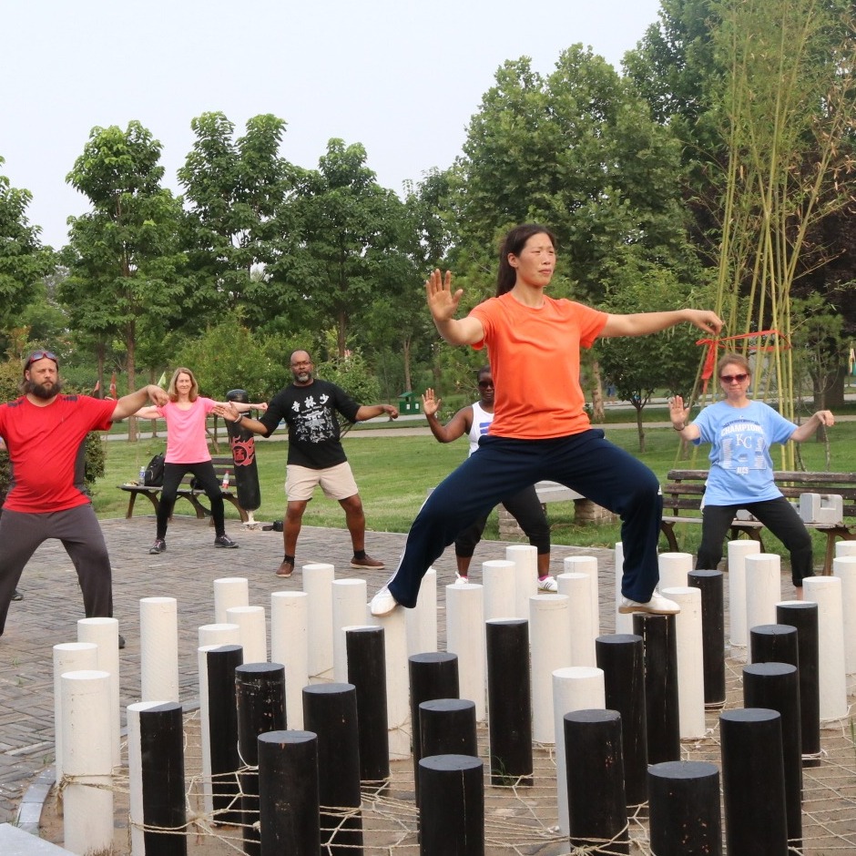 Master Chen Huixian leading students through an outdoor Chen Taijiquan balance exercise