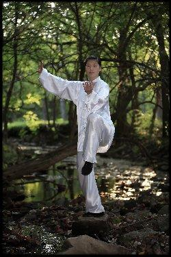 Chen Huixian performing an outdoor balance posture in an archival SCANews image